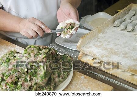Chef spreading filling in dumpling View Large Photo Image Stock Image - Chef spreading filling in dumpling. Fotosearch