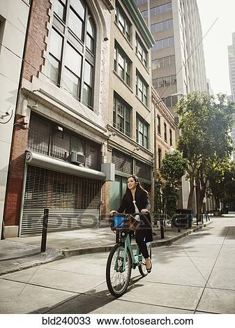 Chinese businesswoman commuting on bicycle in city View Large Photo Image Stock Image - Chinese businesswoman commuting on bicycle in city. Fotosearch