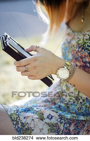 Picture - Chinese woman using digital tablet. Fotosearch