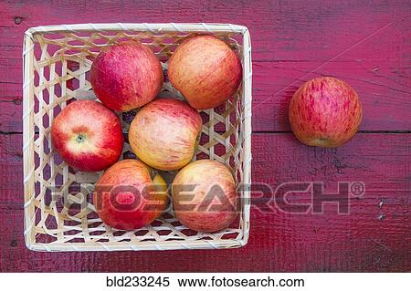Close up of basket of red apples on red wooden table View Large Photo Image Stock Photography - Close up of basket of red apples on red wooden table. Fotosearch