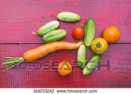 Close up of fresh vegetables on red wooden table View Large Photo Image Stock Image - Close up of fresh vegetables on red wooden table. Fotosearch