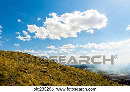 Stock Photography - Clouds over Caucasian friends on distant hill. Fotosearch