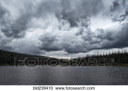 Stock Image - Clouds over lake. Fotosearch