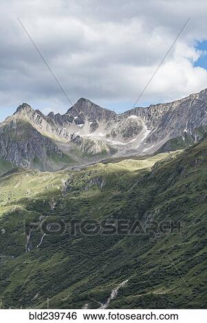 Stock Photograph - Clouds over mountain landscape. Fotosearch