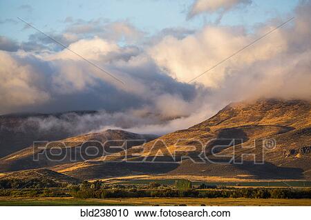 Stock Image - Clouds over mountain range. Fotosearch