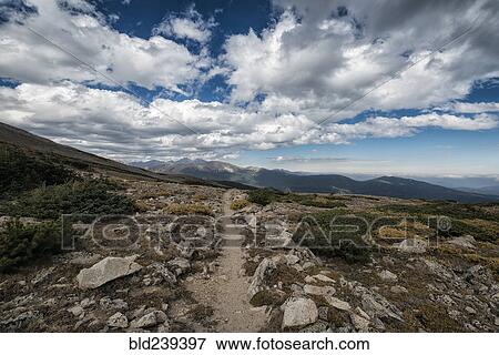 Clouds over rocky landscape View Large Photo Image Stock Photo - Clouds over rocky landscape. Fotosearch