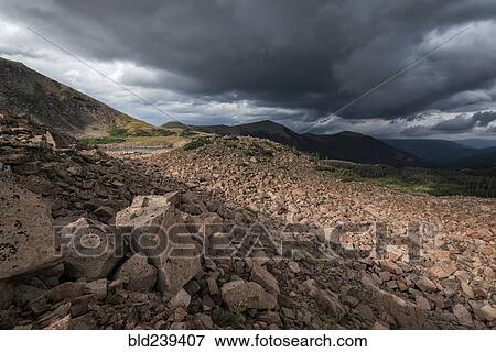 Clouds over rocky landscape View Large Photo Image Stock Photo - Clouds over rocky landscape. Fotosearch