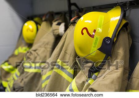 Coats and helmets of fire fighters hanging on hooks View Large Photo Image Picture - Coats and helmets of fire fighters hanging on hooks. Fotosearch