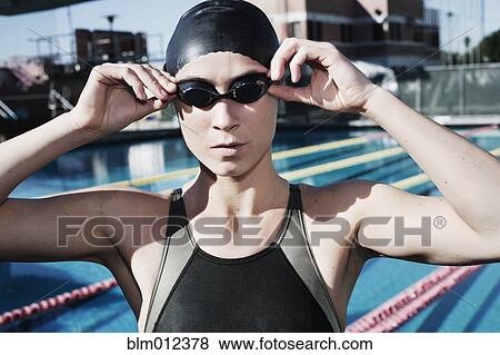Stock Photo - Competitive swimmer adjusting goggles. Fotosearch