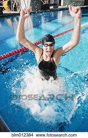 Picture - Competitive swimmer cheering in swimming pool. Fotosearch
