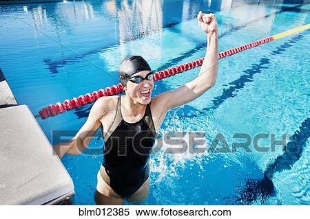 Stock Photography - Competitive swimmer cheering in swimming pool. Fotosearch