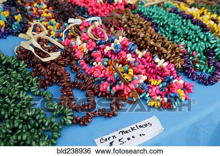 Stock Photograph - Corn necklaces for sale on table. Fotosearch