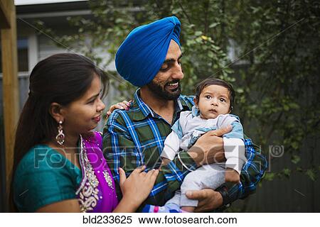 Couple admiring baby son View Large Photo Image Stock Photography - Couple admiring baby son. Fotosearch