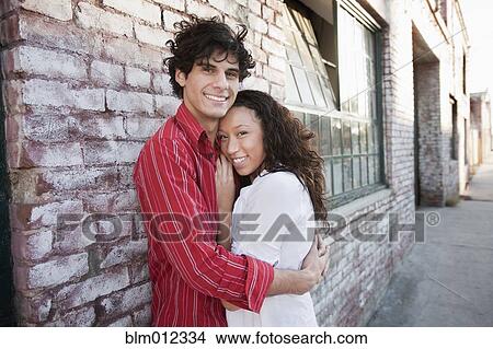 Picture - Couple hugging in urban area. Fotosearch