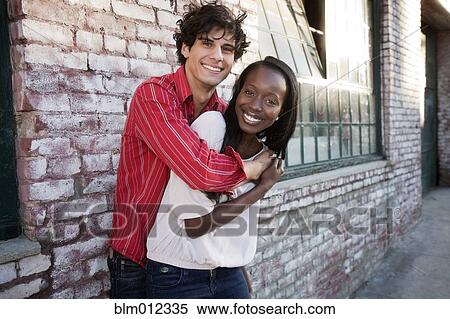 Stock Photography - Couple hugging in urban area. Fotosearch