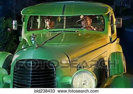 Couple in green vintage car View Large Photo Image Stock Image - Couple in green vintage car. Fotosearch