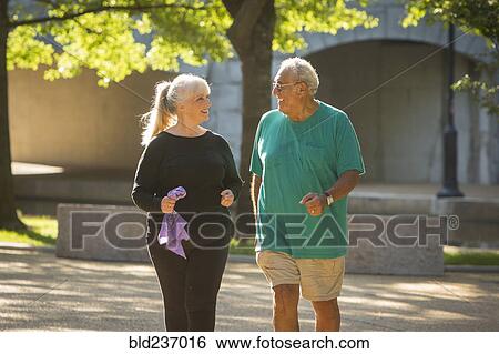 Stock Photograph - Couple walking in park. Fotosearch