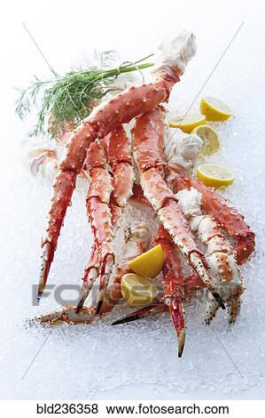 Crab legs and lemons on ice View Large Photo Image Stock Photo - Crab legs and lemons on ice. Fotosearch
