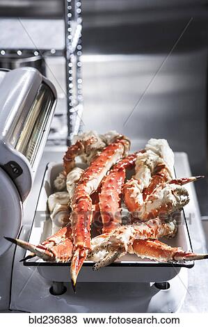 Stock Image - Crab legs on butcher scale. Fotosearch