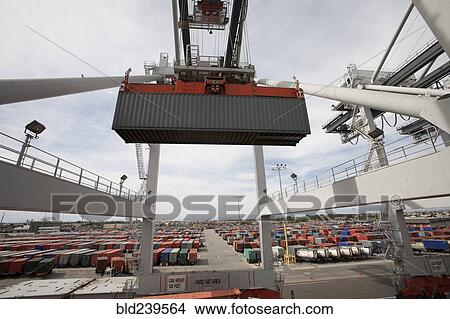 Crane lifting cargo container at port View Large Photo Image Picture - Crane lifting cargo container at port. Fotosearch