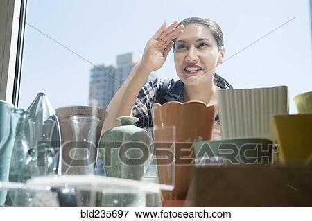 Stock Photo - Curious Mixed Race woman window shopping. Fotosearch