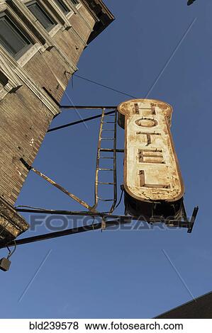 Decrepit hotel sign on building View Large Photo Image Stock Photo - Decrepit hotel sign on building. Fotosearch