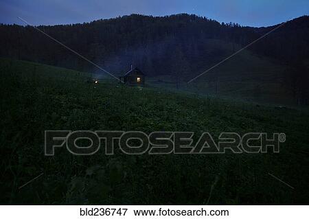 Stock Photo - Distant house on hill at night. Fotosearch