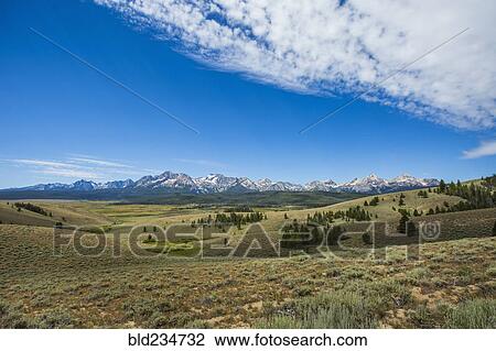 Stock Image - Distant mountain range and rolling landscape. Fotosearch