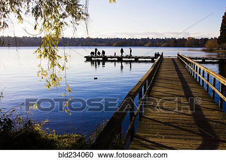Distant people at end of dock at river View Large Photo Image Stock Image - Distant people at end of dock at river. Fotosearch