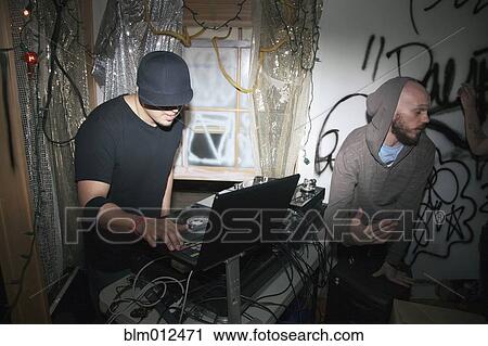 Stock Image - DJ with turntable at party. Fotosearch