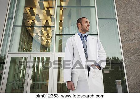 Stock Image - Doctor holding digital tablet outdoors. Fotosearch