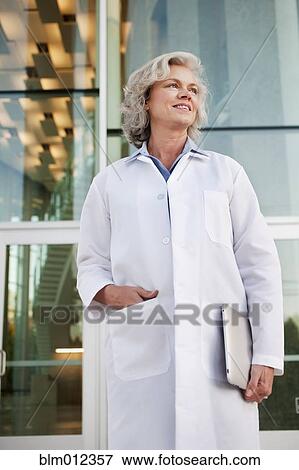 Stock Photo - Doctor holding digital tablet outdoors. Fotosearch