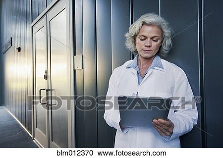 Stock Image - Doctor using digital tablet outdoors. Fotosearch