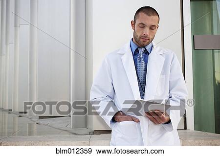 Doctor using digital tablet outdoors View Large Photo Image Stock Photo - Doctor using digital tablet outdoors. Fotosearch