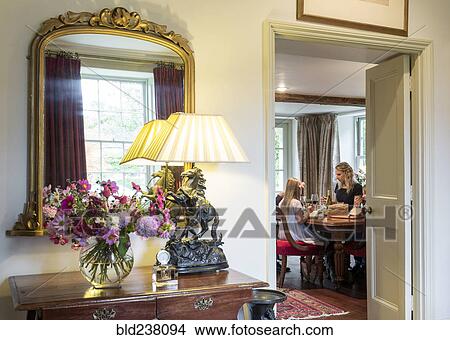 Doorway to Caucasian mother and daughter eating in dining room View Large Photo Image Picture - Doorway to Caucasian mother and daughter eating in dining room. Fotosearch