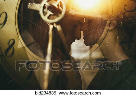 Stock Photography - Double exposure of clock and Caucasian couple. Fotosearch
