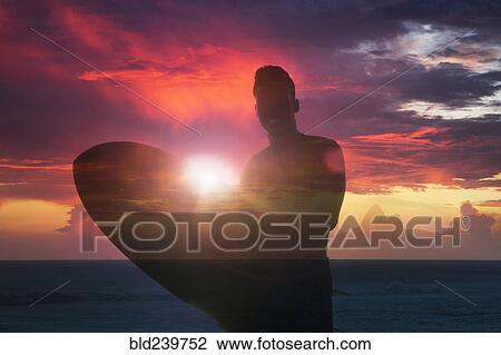Double exposure of smiling Mixed Race man holding surfboard at beach View Large Photo Image Stock Image - Double exposure of smiling Mixed Race man holding surfboard at beach. Fotosearch