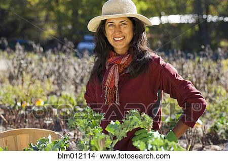 Picture - Ecuadorian woman gardening. Fotosearch