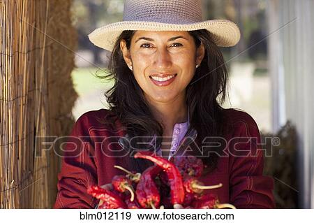 Ecuadorian woman holding red chili peppers View Large Photo Image Stock Photo - Ecuadorian woman holding red chili peppers. Fotosearch
