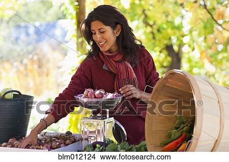 Ecuadorian woman weighing garden vegetables View Large Photo Image Picture - Ecuadorian woman weighing garden vegetables. Fotosearch