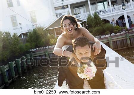 Stock Photo - Egyptian groom carrying bride. Fotosearch