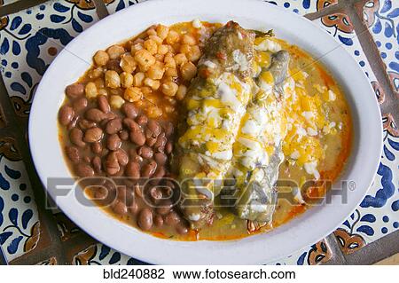 Stock Image - Enchiladas and beans in bowl. Fotosearch