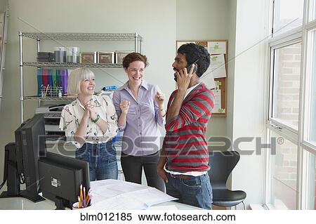 Excited business people in office View Large Photo Image Stock Photography - Excited business people in office. Fotosearch