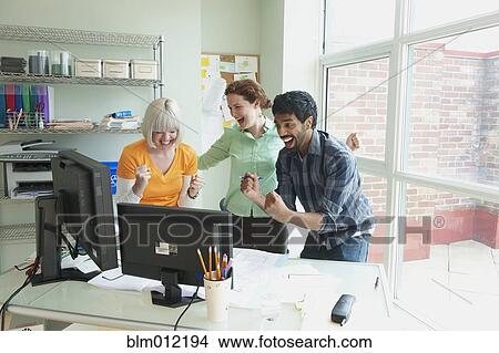 Picture - Excited business people working together in office. Fotosearch
