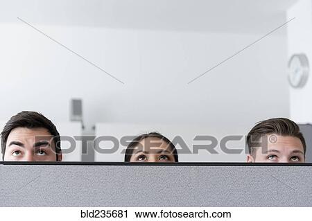 Eyes of business people looking up over cubicle wall in office View Large Photo Image Stock Image - Eyes of business people looking up over cubicle wall in office. Fotosearch