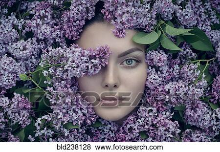 Face of Caucasian woman surrounded by purple flowers View Large Photo Image Stock Photo - Face of Caucasian woman surrounded by purple flowers. Fotosearch