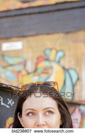 Face of Thai woman near graffiti on urban wall View Large Photo Image Stock Photo - Face of Thai woman near graffiti on urban wall. Fotosearch