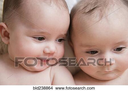 Picture - Faces of Caucasian twin baby girls. Fotosearch
