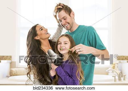 Family grooming each other in bathroom View Large Photo Image Stock Photograph - Family grooming each other in bathroom. Fotosearch