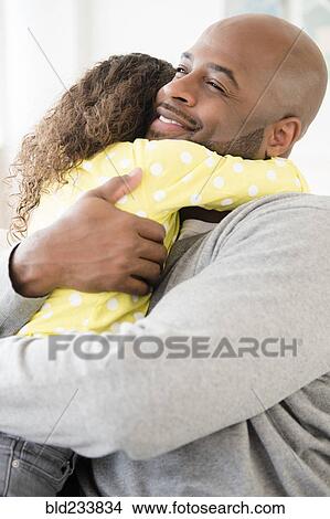 Picture - Father and daughter hugging. Fotosearch
